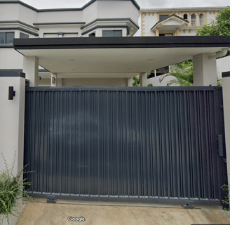 a gate in front of a this beautiful Thai house for sale