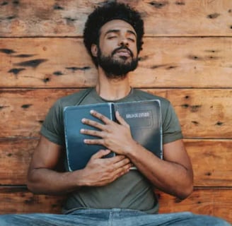 a man with a beard and a beard, holding a book