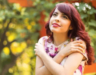 a woman with red hair and a pink dress