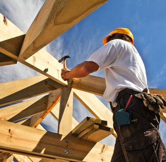 a construction worker is working on a roof; buildwithampro.com