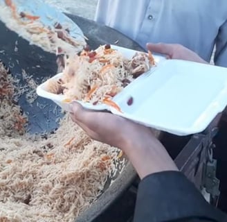 a person holding a plate with food in it
