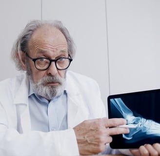 Male Doctor Discussing a Foot Xray and Link to AnatomyVideos.com