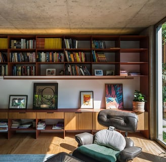 A well-organized bookshelf with ornament frames