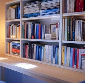 a book shelf with books and a lamp