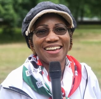 a woman in a hat and NDC scarf around her neck