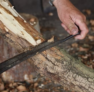 a person holding a draw knife in their hands