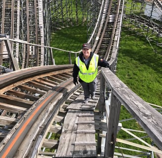 a female inspector on a wooden roller coaster