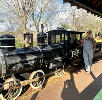 a man standing next to a train