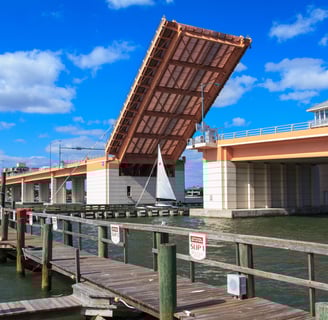 a bridge with a boat going under a bridge