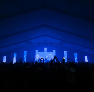 Congregation worshiping with vibrant visuals displaying worship lyrics and scripture on large screen
