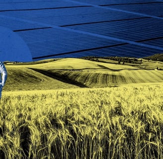 a man standing in a field with a blue sky in the background