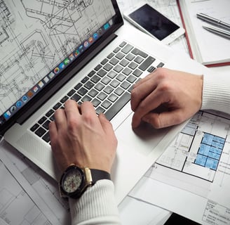 a man working on a laptop computer and a watch