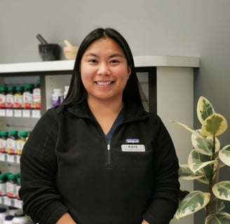 woman with long black hair a name tag on her upper right side