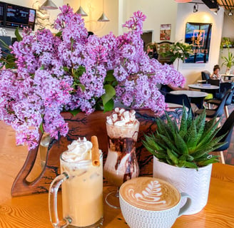 a vase of flowers and a coffee mug on a table