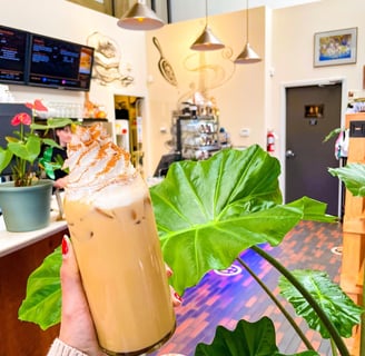 a person holding a drink in a restaurant