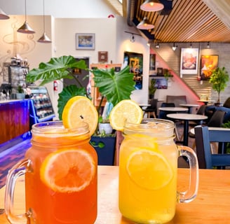 two mason jars filled with ice tea lemonade