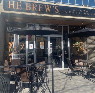 a coffee house with tables and chairs with an outside patio