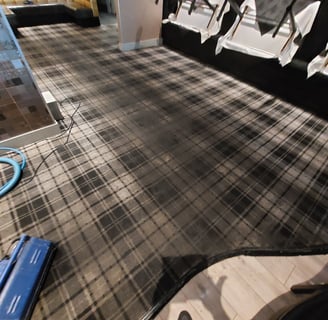 absolutely heavily dirty restaurant carpet in the process of a deep clean with part of the carpet already deep cleaned