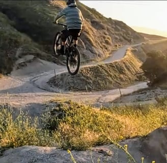A mtb rider hitting a big double jump