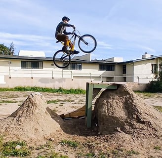Mountain biker clearing a double jump with gap in the middle