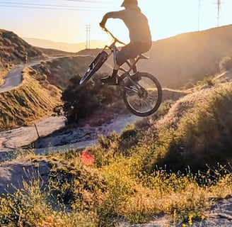 Mountain biker with clean jump form, relaxed knees and centered body