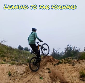 This image shows a rider leaning over the bars at the lip of the jump, leading to a nose-heavy postu