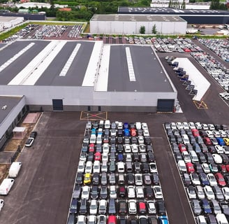 a parking lot with cars parked in front of a building