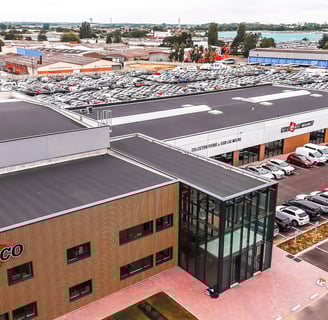 a large building with a lot of cars parked in front of it