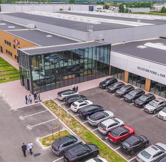 a parking lot with cars parked in front of a building