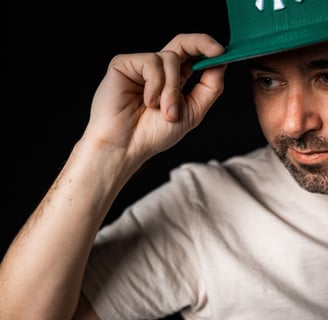 a man in a green hat with a baseball cap on
