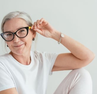 a woman with glasses and a white shirt