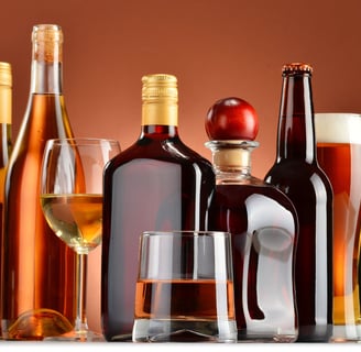 a variety of alcohol bottles and glasses on a table