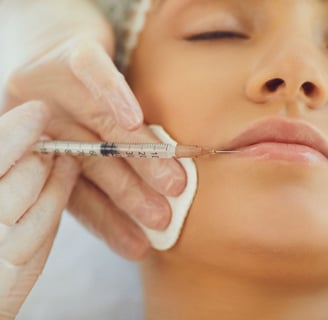 a woman getting a injection from a syll