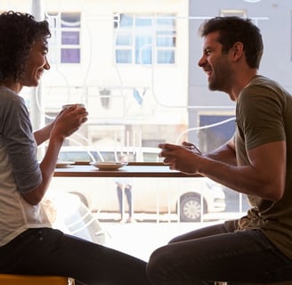 a man and woman sitting at a table