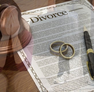 divorce papers with wedding bands on top of them