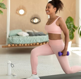 a woman in pink sports bras and a pink bra top exercising