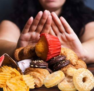 a woman is holding a pastry and a pastry