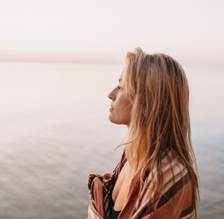 a woman in a blanket blanket on a beach