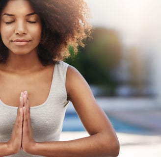 a woman in a tank top doing yoga