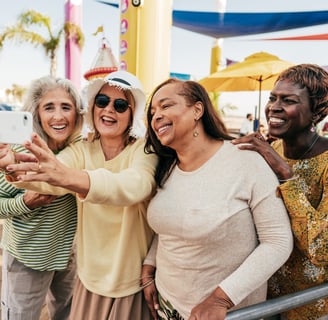 a group of women taking a selfie with a cell phone