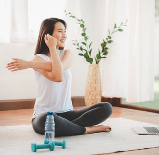 woman sitting on floor stretching 