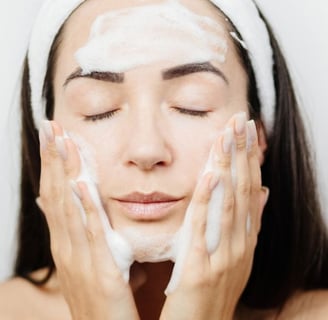 woman cleansing her skin