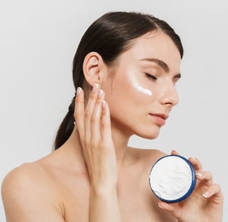 woman mosturizing her face