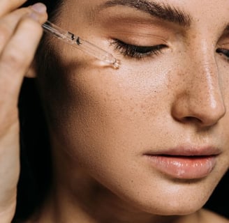 woman putting serum on her face