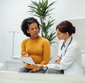 a doctor and a woman in a hospital room