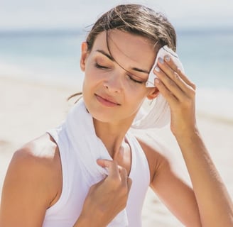 woman wiping sweat off of her face