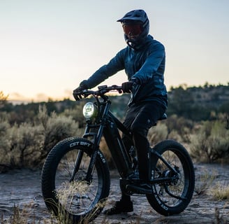 a man riding a Vitilan bike in the desert