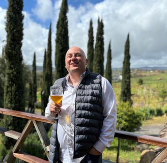 a man in a vest and vest with a beer glass