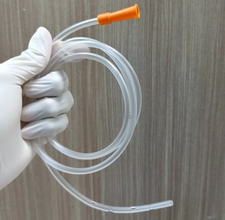 someone wearing gloves and holding a feeding tube