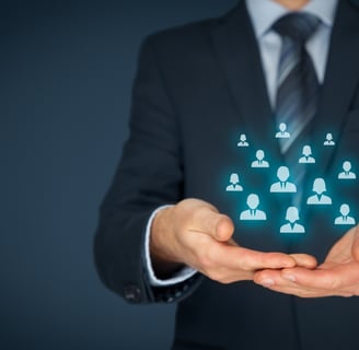 Businessman holding holographic icons of people, symbolizing diverse customers served by Integrix Services